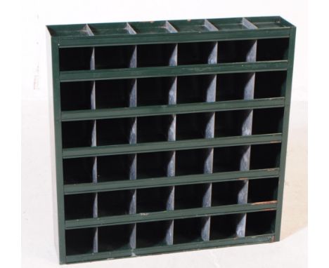 A vintage mid 20th century painted metal industrial storage shelving unit. The shelves painted in a dark green colourway. Fea