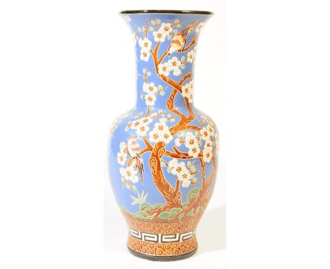 A large vintage 20th century Japanese ceramic pottery floor standing vase. In blue ground with white blossoms tree and exotic