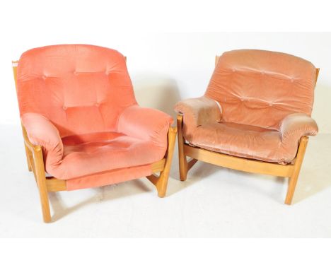 Ercol - A pair of mid 20th century Ercol Wychwood beech and elm lounge armchairs. The chairs featuring a wooden frame with cu