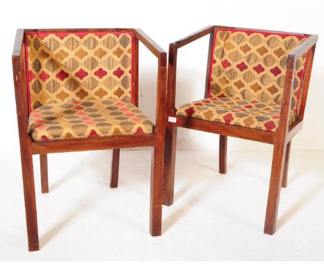 A pair of vintage 20th century Art Deco pub / bistro armchairs. Of mahogany construction, repeating pattern upholstered fabri