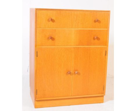 British Modern Design - Mid 20th century light oak small cupboard / sideboard. Rectangular form with bank of two drawers abov