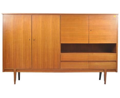 British Modern Design - A large vintage 20th century teak veneered highboard / sideboard wall unit. Rectangular form with a c