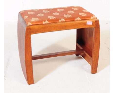 A vintage 20th century Art Deco stool. Of rectangular form with upholstered fabric with leaf design. Curved oak supports unit