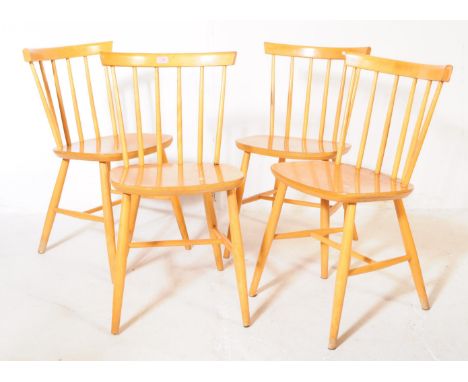 Manner of Ercol - A set of four elm stick back dining / kitchen chairs. Having angled circular tapering legs united by H stre