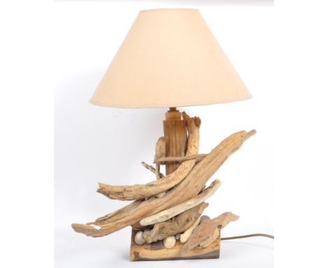 A contemporary driftwood table lamp comprising of driftwood pieces and shells for base with white shade. Measures approx. 57x