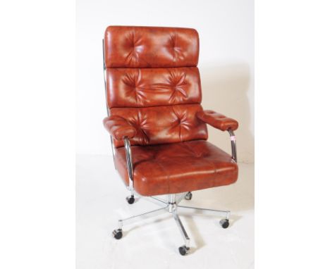 A contemporary office swivel desk armchair. With rectangular button back rest, with padded elbow rests on cushioned seat. Wit