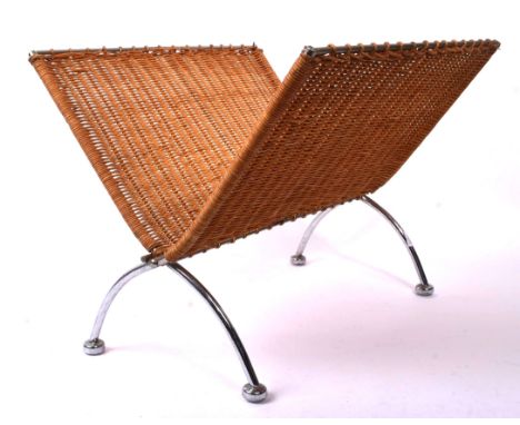 A vintage folding metal and wicker magazine rack. On curved chrome metal legs with woven rattan work to body. Measures approx