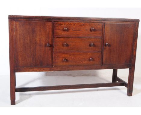 H Morris for Cotswold company - A vintage mid 20th century Cotswold school oak sideboard credenza. Of rectangular form with b