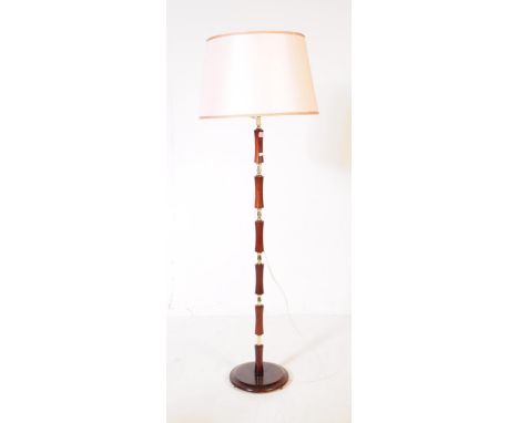 British Modern Design - A mid 20th century brass and wood floor standing standard lamp. The lamp having a rounded stepped woo