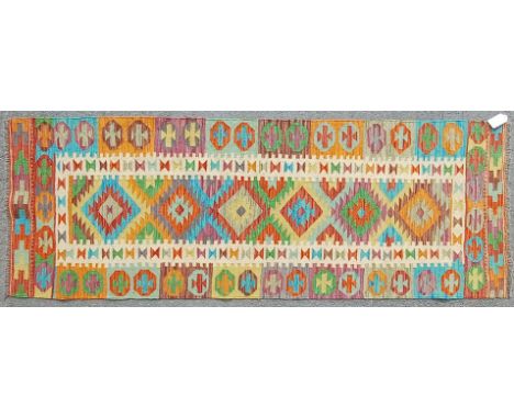 A vintage 20th century Anatolian Turkish kilim runner floor rug. Having polychrome geometric nazarlik patterns to the central