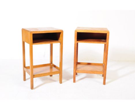 A pair of mid 20th century War Department oak bedside tables. The bedsides of oak construction having an open faced shelf to 