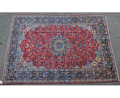 A vintage 20th century Persian Islamic central Najaabad carpet floor rug. With central blue medallion with red surround with 
