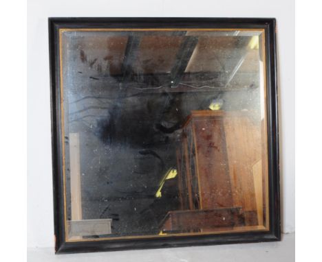 A vintage 20th century overmantel wall mirror. Of square form with gilt banding ebonised wood frame with bevelled edge mirror