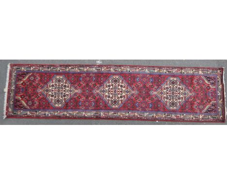 A vintage 20th century Persian Islamic carpet floor runner run. Having geometric repeating pattern with further decoration to