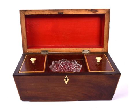 An early 19th century George III mahogany inlaid tea caddy box. The box being of rectangular form with canted edges and ring 