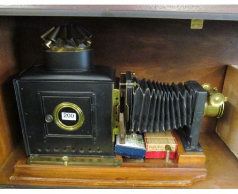 A Thornton Pickard magic lantern bearing label with two boxes of slides (no lamp)