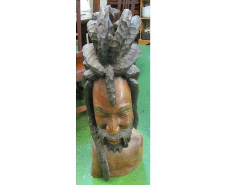 A large carved wood model of a man with dreadlocks