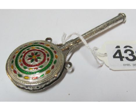 A white metal and enamel rattle