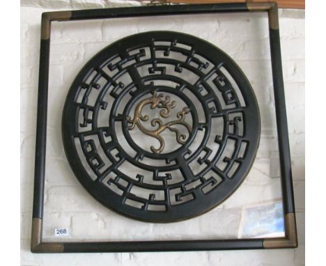 A circular oriental panel on perspex
