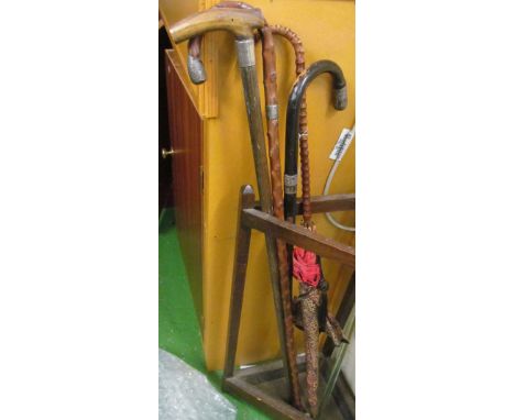 Three Victorian walking sticks two with silver mounts and a vintage parasol