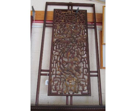 An oriental wall panel with decorative gilt centre