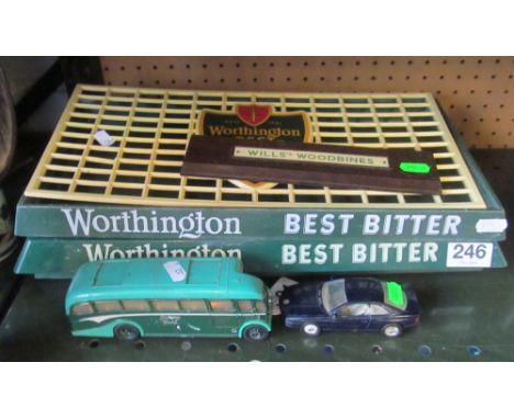 Three Worthington beer trays, a cribbage board, Corgi coach and a BMW