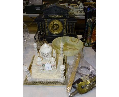 A black slate case striking mantel clock of architectural design, (a/f), an alabaster model of the Taj Mahal, (a/f), 23.5cm h
