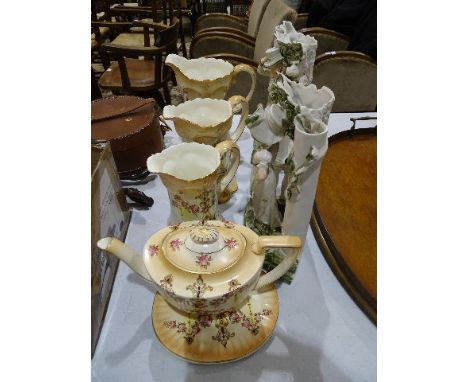 A graduated set of three Crown Devon 'Etria' decorated jugs, a similarly-decorated teapot and oval stand, together with a pai