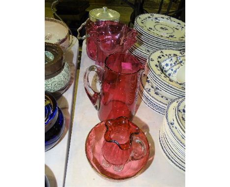 A cranberry glass biscuit barrel with plated mount, lid and handle, 27cm high overall, a cranberry glass bowl with enamel dec