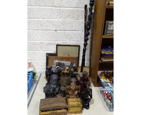 A collection of wooden items, including a tribal carved walking stick, figures and miscellaneous items. 
