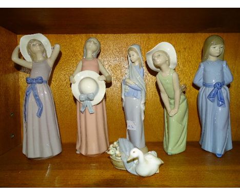 A collection of four Lladro figures of young women, another of a duck with ducklings in a basket and a Nao figure of a young 