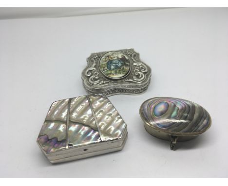 Two Mexican Silver boxes decorated with mother of pearl and one other with an enamel oval with figures. (3)