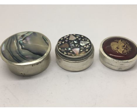 Three small silver boxes decorated with mother of pearl and one with enamel (3)
