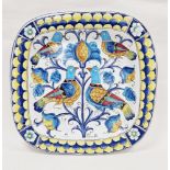 Italian pottery large charger, rounded square and decorated in bright polychrome colours with