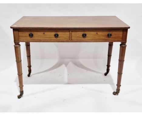 Victorian mahogany side table with rounded corners, two frieze drawers with metal drop ring handles and raised on turned band