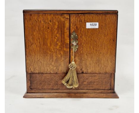 Late 19th/early 20th century oak smoker's cabinet&nbsp;of square form with two brass drop ring handles to side, the twin door