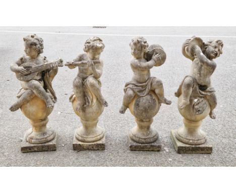 Set of four composite stone garden statues&nbsp;in the form of musical putti playing tambourine, mandolin, flute and cymbals,