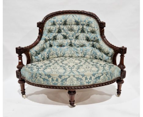 Victorian salon corner chair, the mahogany frame elaborately carved including flowers, scrolling foliage and twisting ribbons