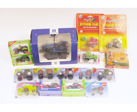 15 boxed and carded diecast farm vehicles&nbsp;including Agritec model New Holland Caterpillar, two Britains Junior Farm item