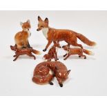 Collection of Beswick Pottery models of foxes in sizes, naturalistically modelled seated and