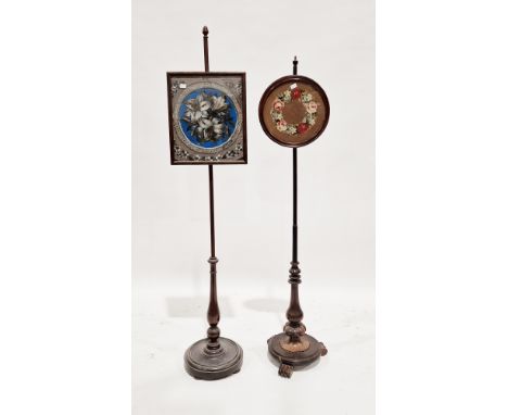 Two 19th century mahogany polescreens, each raised on circular platform bases, one polescreen with a square beaded floral pat