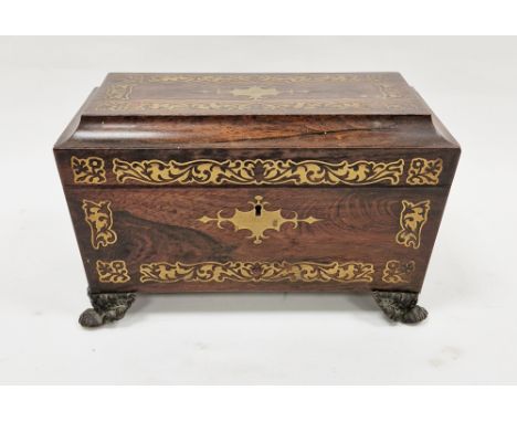 Early 19th century rosewood and brass inlaid tea caddy of sarcophagus form, the hinged lid opening to two lidded tea compartm