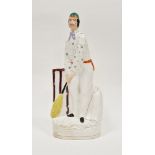 Staffordshire pottery figure of a cricketer, circa 1865, modelled standing wearing a green cap and