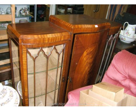 A late Victorian flame Mahogany breakfront Display Cabinet having central serpentine section with single panel door, oval fla