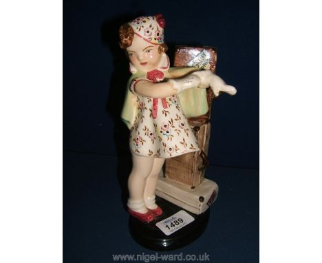 A Goldscheider figure of a small Girl in floral dress with a pile of suitcases to one side, possibly a lamp, a/f 8 3/4''