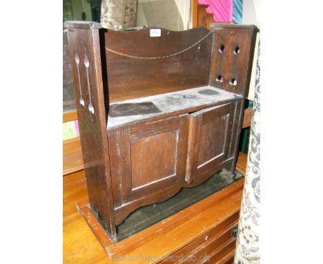 An Edwardian Oak Wall Cupboard, having bookshelf top with pierced and fret-cut sides, over lower pair of opposing single pane