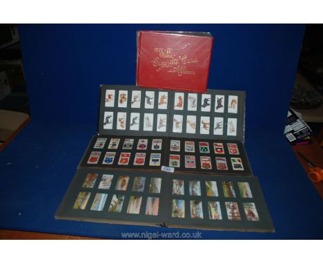 Four Cigarette Card Albums, two being Players (birds/dogs) and two Wills (Army/Ships)
