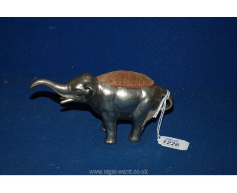 A large 19th c. metal Pin Cushion in the shape of an Elephant with outstretched trunk having original velvet pad, 8" long
