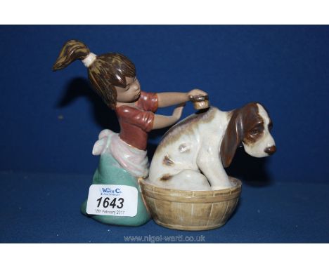 A Lladro figure of a Girl bathing her Dog