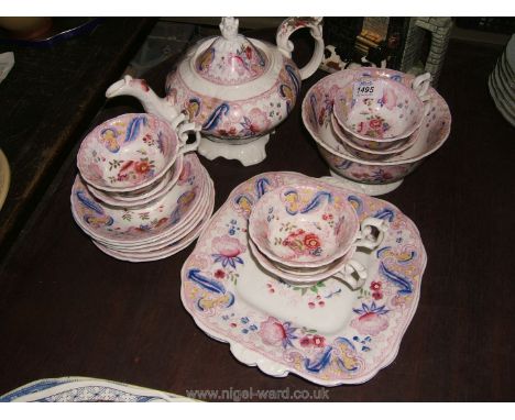A vintage Teaset including large teapot a/f, six cups and saucers, two Bread and Butter Plates in a pale pink with blue and r